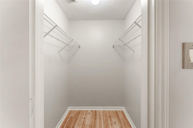 spacious closet with hardwood / wood-style floors