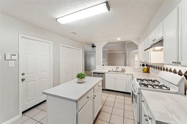 kitchen with white cabinets, a center island, stainless steel dishwasher, and gas range gas stove