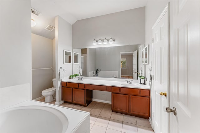 bathroom with a bathtub, tile patterned flooring, vaulted ceiling, and vanity