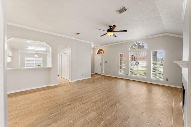 unfurnished living room with ornamental molding, a textured ceiling, ceiling fan, and vaulted ceiling