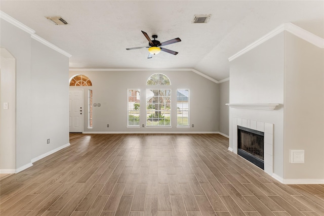 unfurnished living room with lofted ceiling, a fireplace, ceiling fan, and crown molding