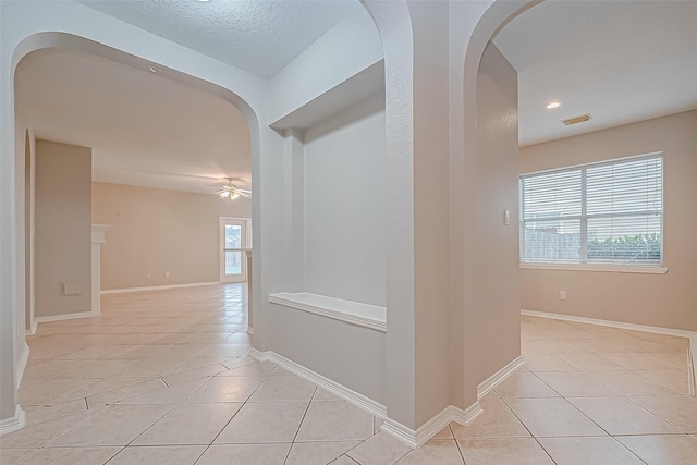 corridor with light tile patterned floors