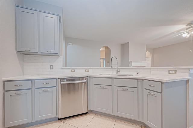 kitchen with dishwasher, light tile patterned floors, backsplash, ceiling fan, and sink