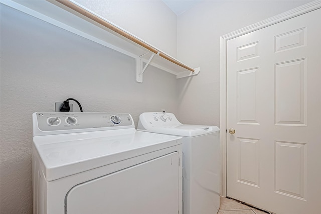 laundry room with light tile patterned flooring and independent washer and dryer