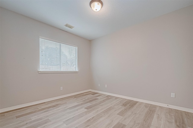 spare room with light hardwood / wood-style flooring