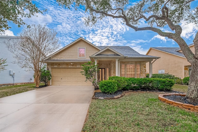 view of front of home with a front yard and a garage