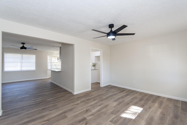 spare room featuring a textured ceiling, dark hardwood / wood-style flooring, and ceiling fan