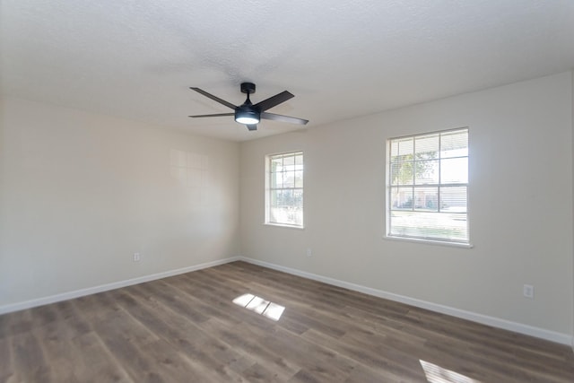 unfurnished room featuring ceiling fan, dark wood-type flooring, and a textured ceiling