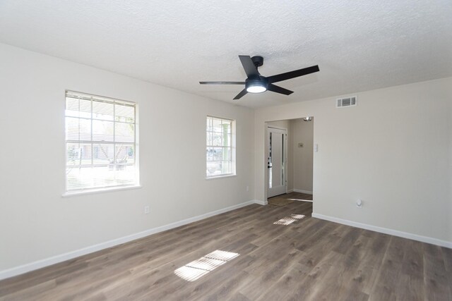 spare room featuring ceiling fan, a textured ceiling, and dark hardwood / wood-style floors