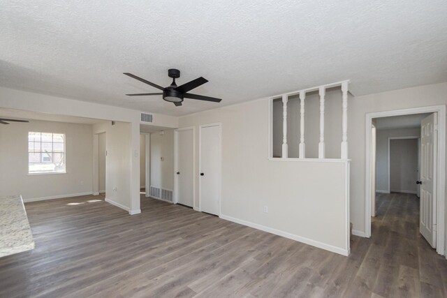 spare room featuring a textured ceiling, ceiling fan, and wood-type flooring