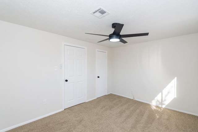 unfurnished bedroom featuring ceiling fan and carpet flooring