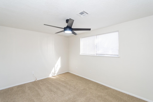 empty room featuring ceiling fan and carpet flooring