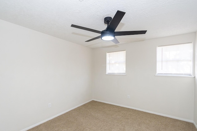 carpeted empty room featuring a textured ceiling and ceiling fan