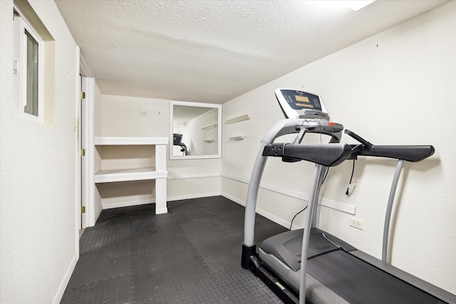 workout room featuring a textured ceiling