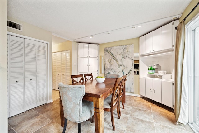 dining space featuring a textured ceiling