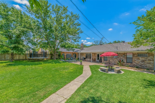 view of yard featuring a patio area and a trampoline