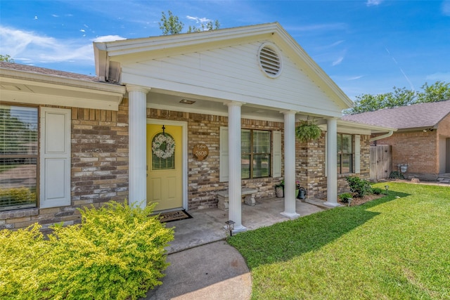 doorway to property with a lawn