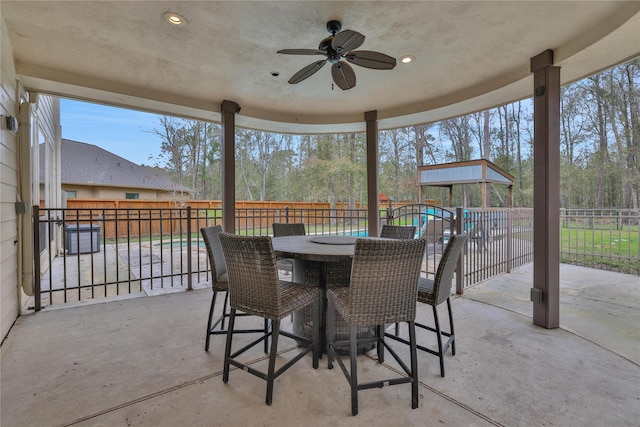 view of patio featuring ceiling fan and a playground