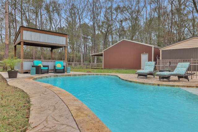 view of pool with an outbuilding and an outdoor hangout area