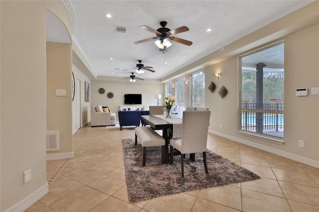 tiled dining area featuring crown molding