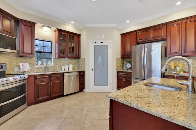 kitchen with sink, appliances with stainless steel finishes, ornamental molding, and tasteful backsplash