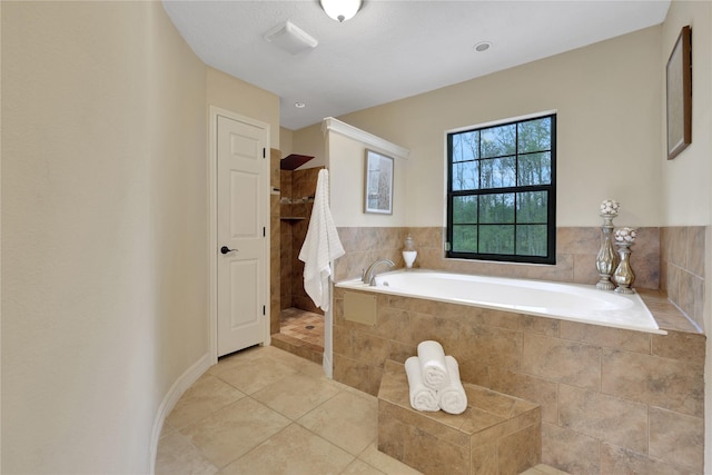 bathroom with independent shower and bath and tile patterned floors