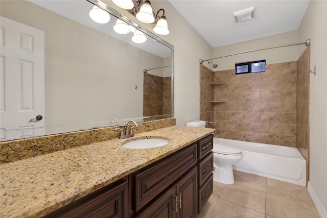 full bathroom featuring toilet, vanity, tiled shower / bath combo, and tile patterned flooring