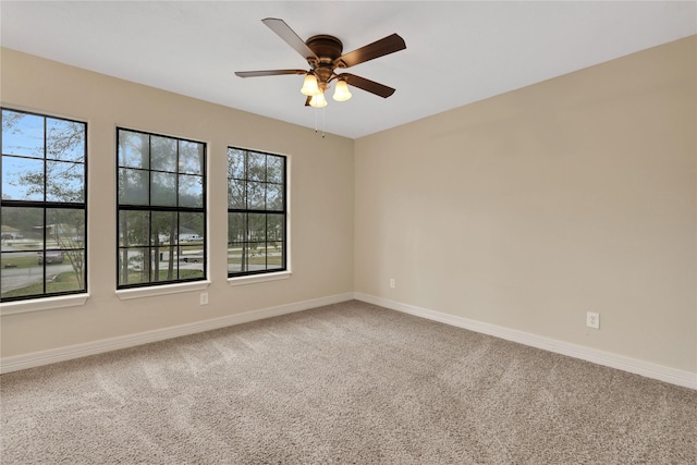 carpeted spare room with ceiling fan