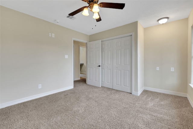 unfurnished bedroom with light colored carpet, a closet, and ceiling fan