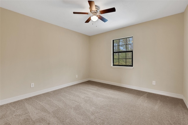 carpeted spare room featuring ceiling fan