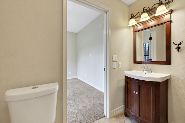 bathroom featuring tile patterned floors, vanity, and toilet