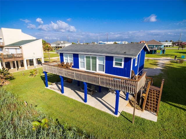 rear view of house with a yard, a deck, and a patio area