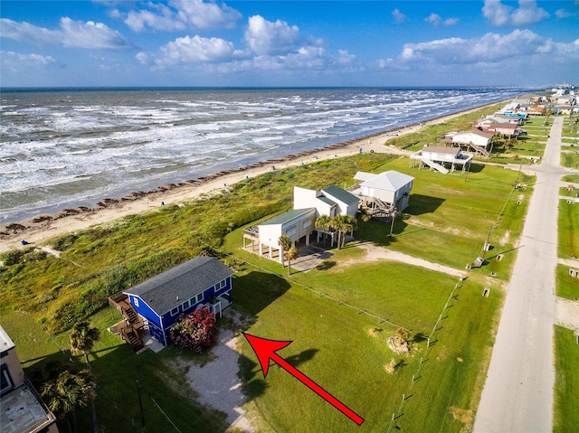 drone / aerial view featuring a water view and a beach view