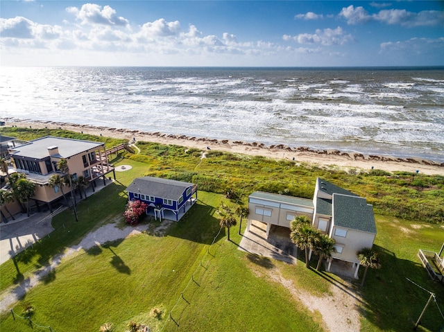 drone / aerial view featuring a water view and a view of the beach