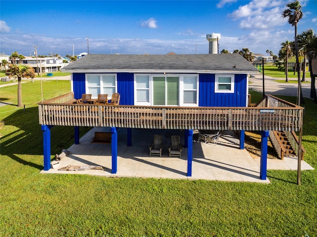 back of house with a patio, a wooden deck, and a yard