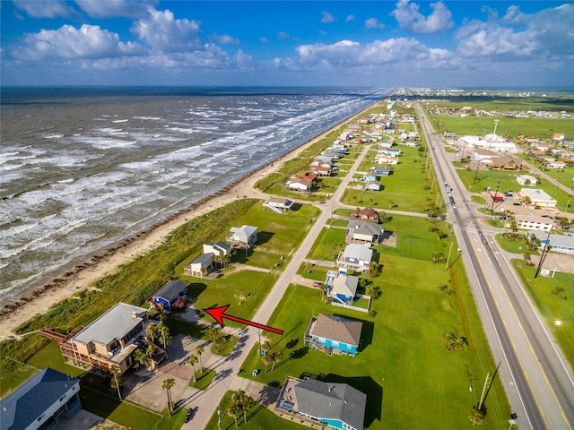 aerial view featuring a view of the beach and a water view