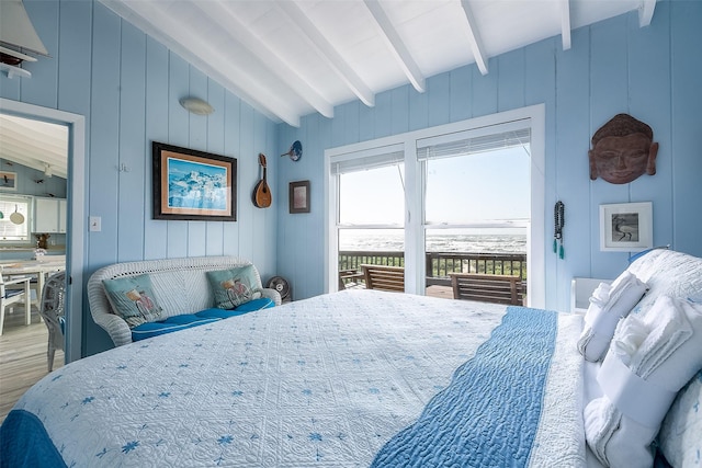 bedroom featuring hardwood / wood-style flooring and vaulted ceiling with beams