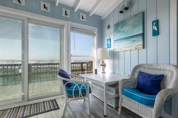 sunroom featuring beam ceiling