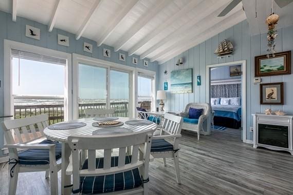 sunroom / solarium with lofted ceiling with beams