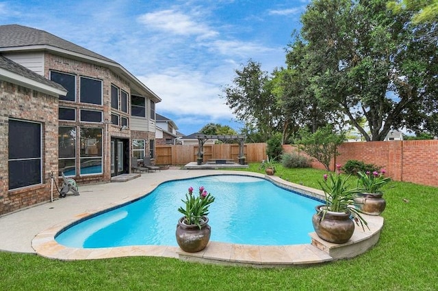 view of pool featuring a lawn, a patio area, and a pergola