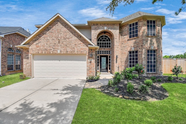 view of front of property with a front yard and a garage