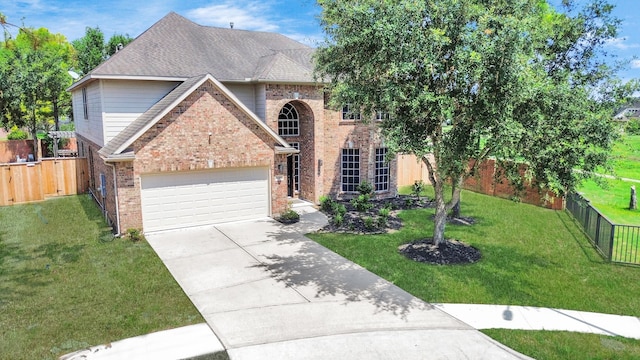 view of front of property with a garage and a front yard