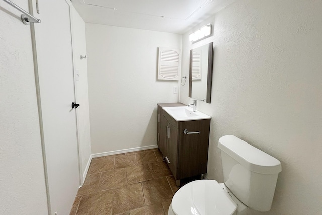 bathroom featuring toilet and vanity