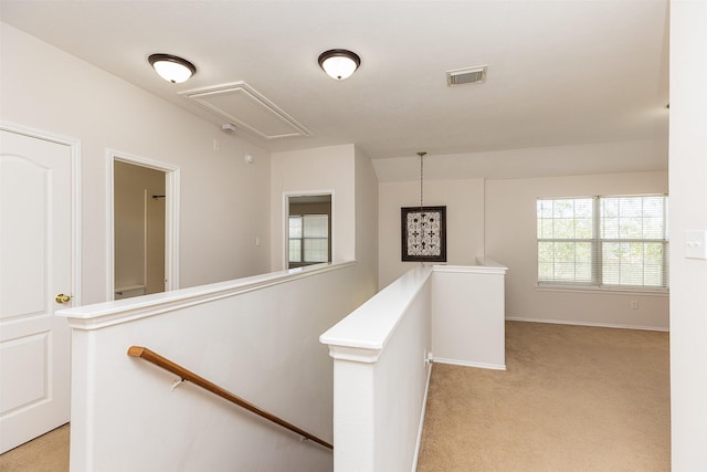 hallway featuring light carpet