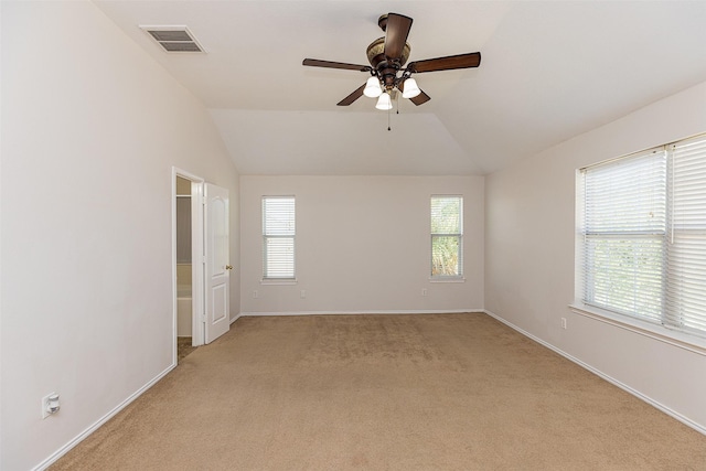 carpeted spare room featuring ceiling fan and lofted ceiling