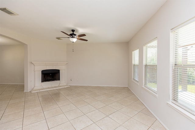 unfurnished living room featuring ceiling fan and light tile patterned floors