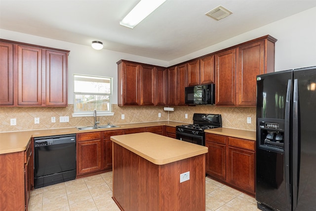 kitchen featuring light tile patterned flooring, sink, a center island, decorative backsplash, and black appliances