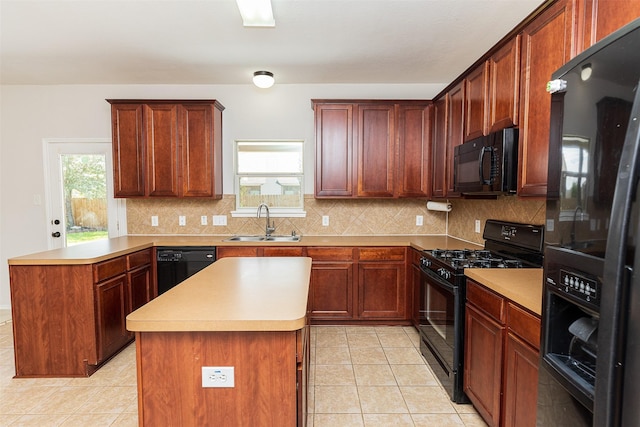 kitchen with decorative backsplash, sink, a kitchen island, and black appliances