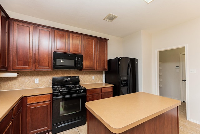 kitchen featuring tasteful backsplash, light tile patterned flooring, a kitchen island, and black appliances