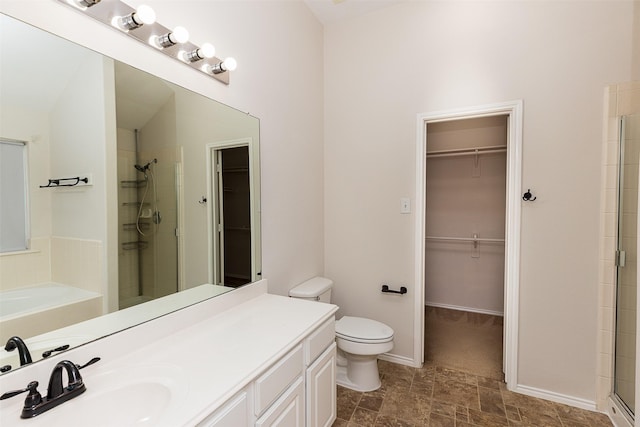 bathroom featuring vanity, vaulted ceiling, toilet, and walk in shower